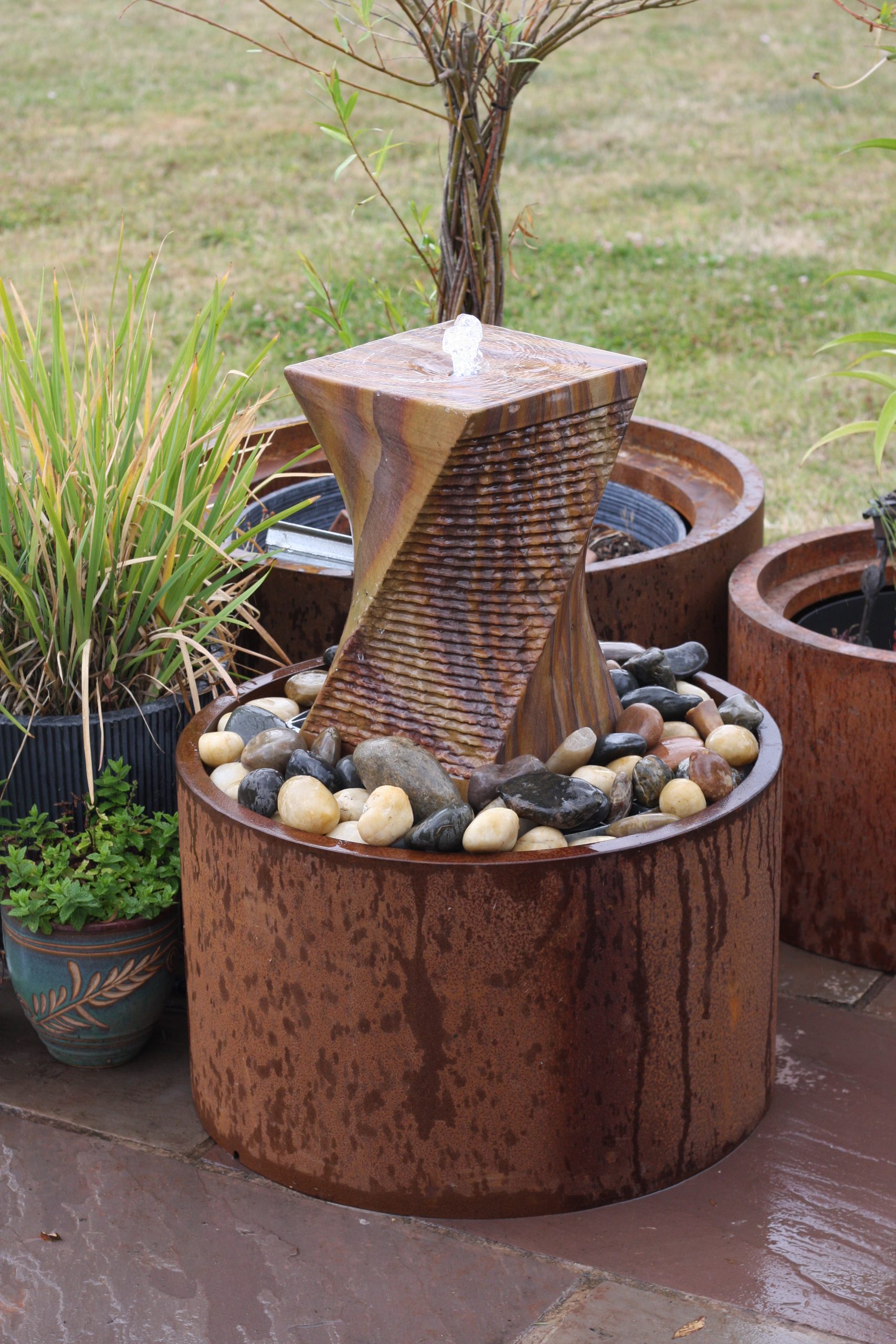 COMPLETE WATER FEATURE  - 40CM H Rainbow Sandstone Twist, dia61cm Corten surround+6008-55RES./GRID+6008ECO-S pump and light kit